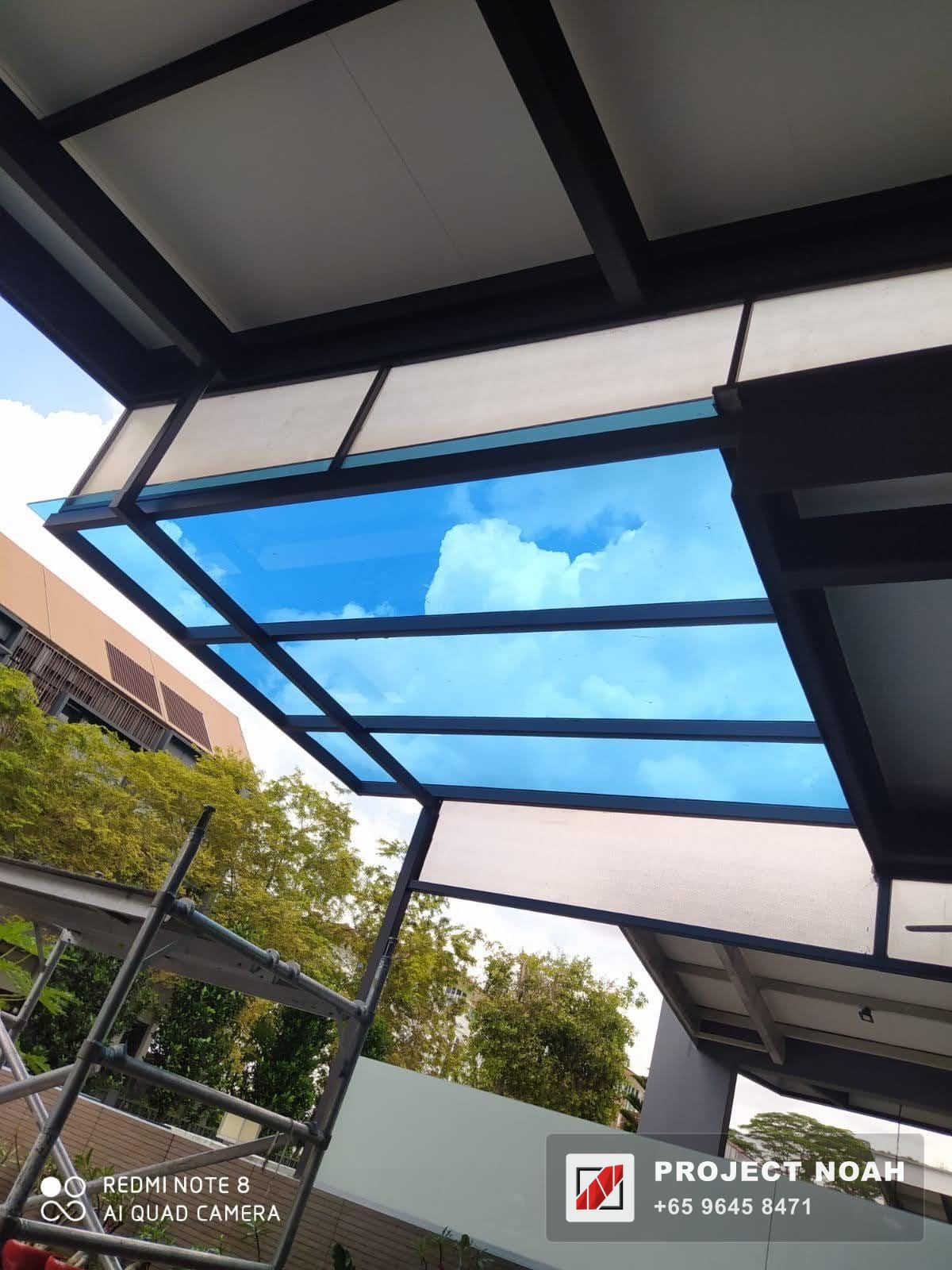 Steel-framed glass canopy over an entrance